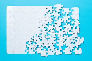 Jigsaw puzzle pieces on blue background