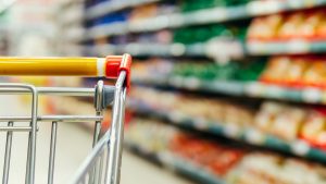 shopping trolley in supermarket aisle, copy space